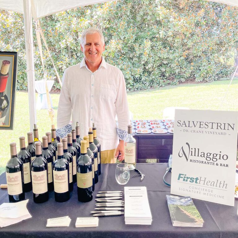 employee standing at vendor table from salvestring and villagio restaurant