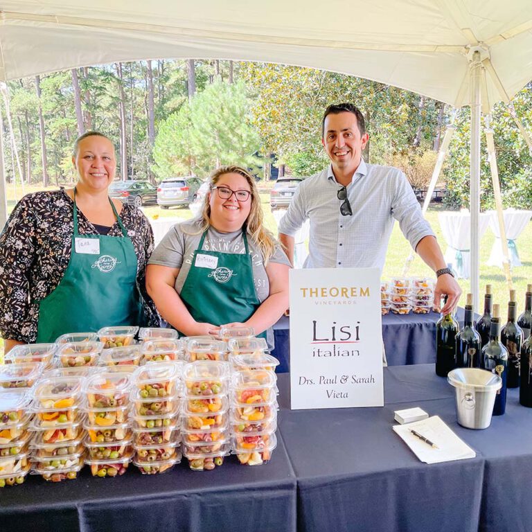 employees standing at vendor table from theory and lissi italian