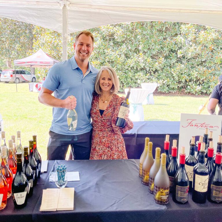 employees standing at vendor table from fantesca wines