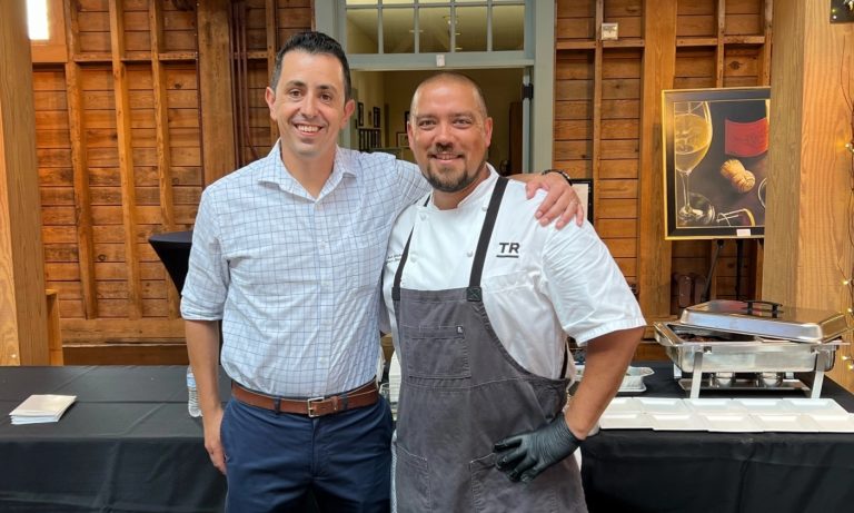 2 men posing together with arm around shoulder